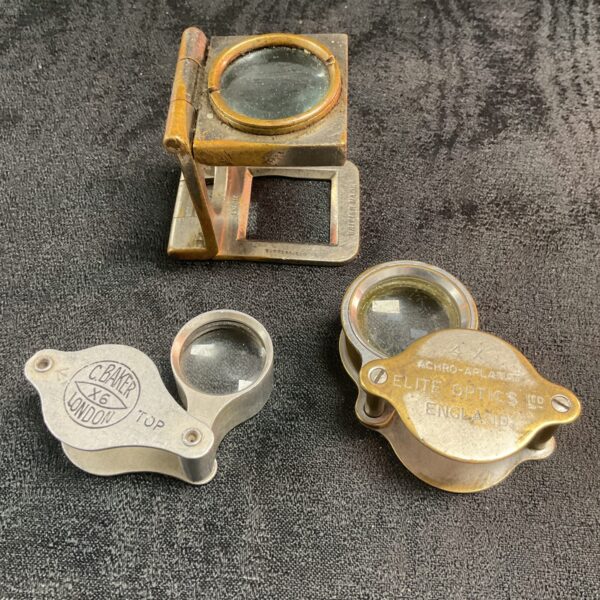 Group of three vintage brass magnifying glasses, antique optics.