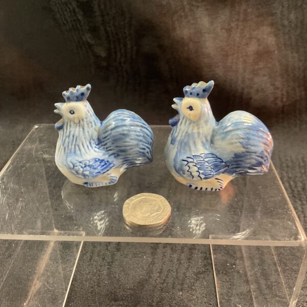 Vintage blue and white chicken salt and pepper shakers on display.