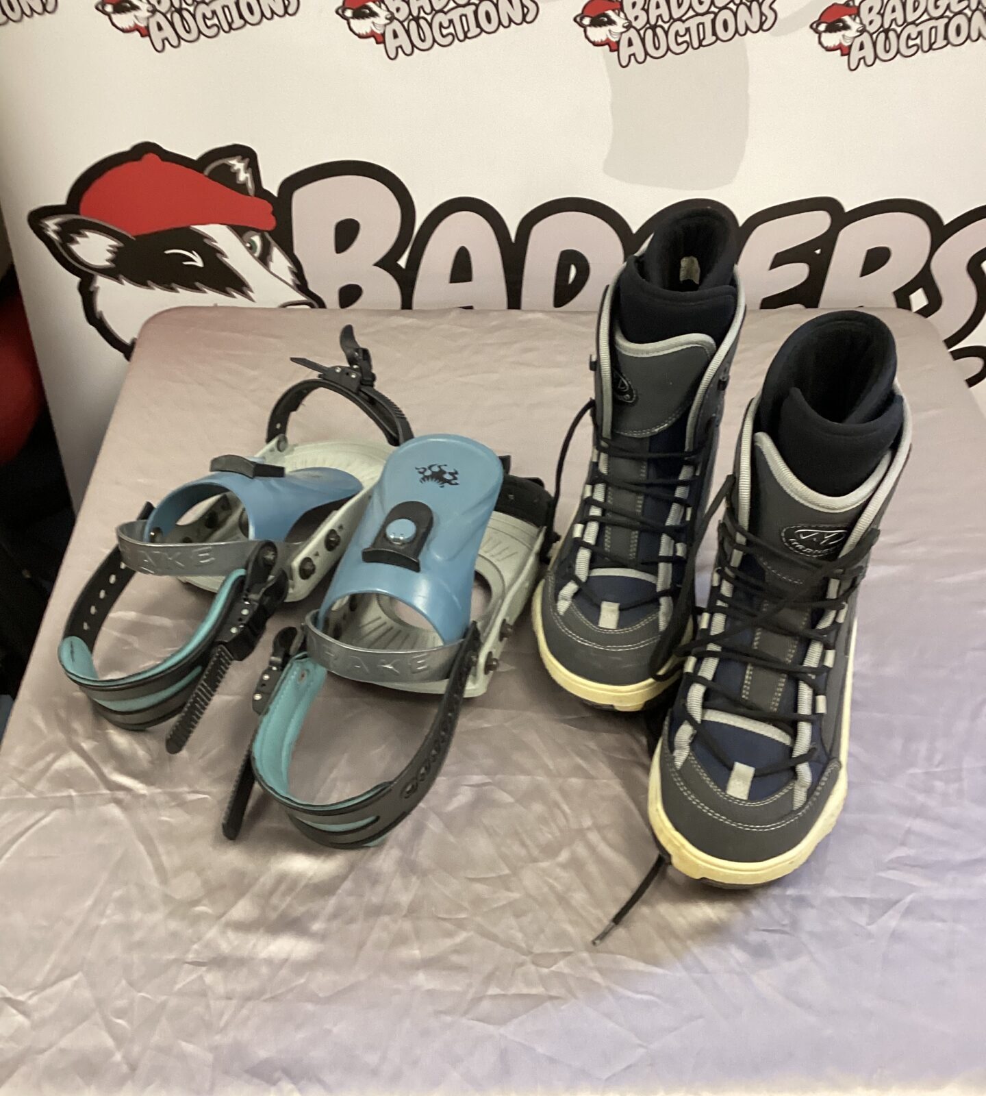 Pair of snow boots with drake snow board clips