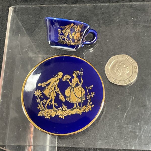 Antique Limoges miniature plate and cup with hand-painted scene.