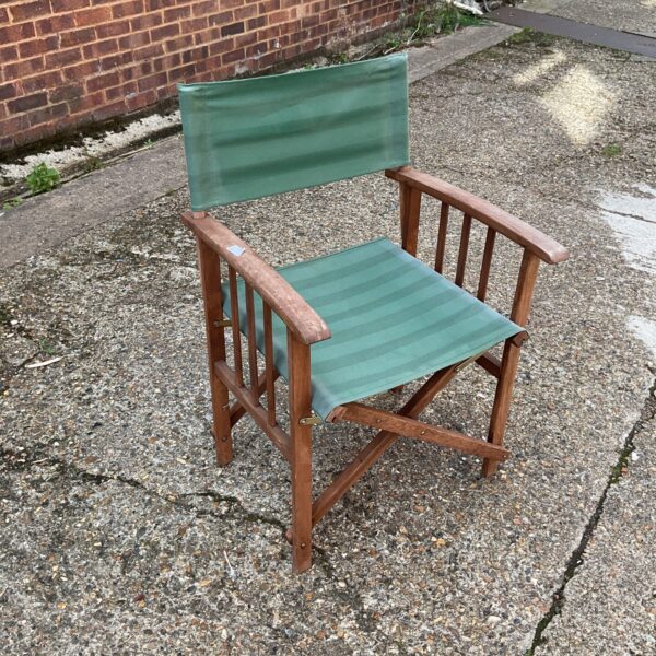 Vintage wooden directors chair with faded canvas seat.