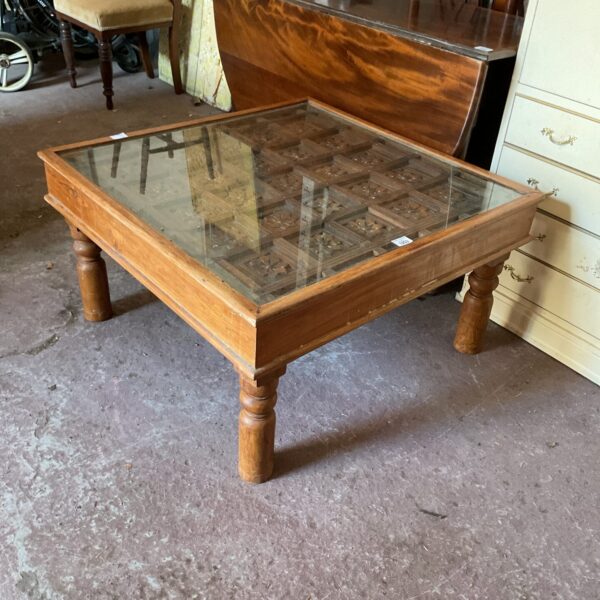 Vintage 3’x3’ glass topped coffee table with 17th century wall panel (one leg in need of repair)