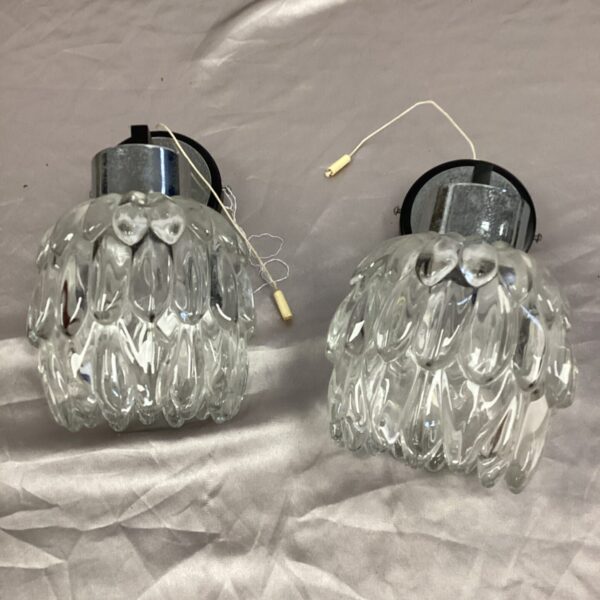 Vintage pineapple wall sconces with glass shades.