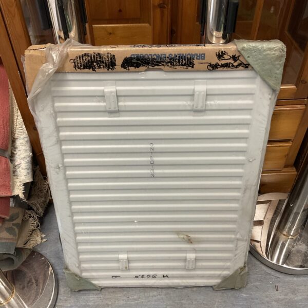 New white wall mounted radiator in original packaging.