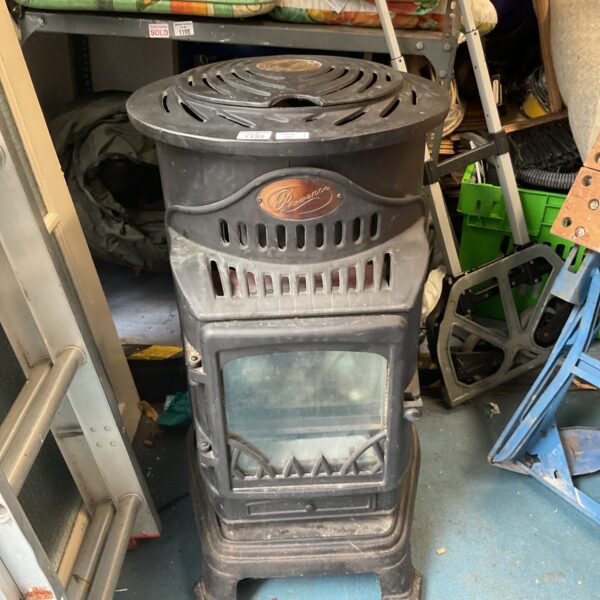 Vintage Provence gas heater with gas bottle for portable indoor warmth.