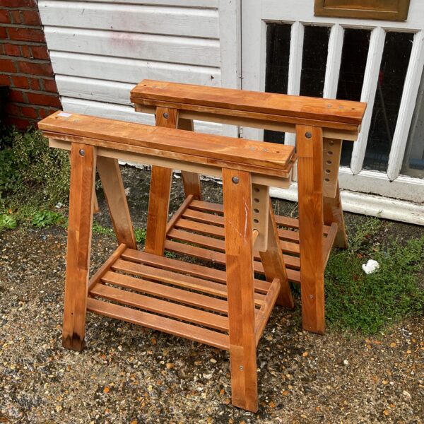 Pair of rustic wooden trestles for garden or workshop use.