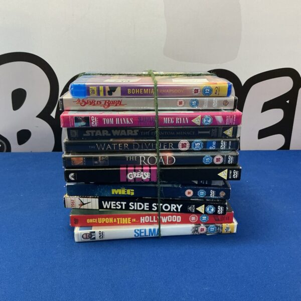 Sealed DVD selection with various movie titles in original packaging.