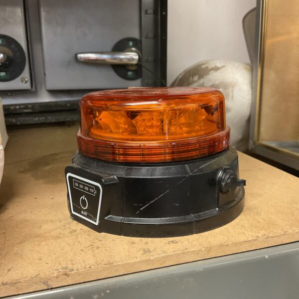 Bright orange rechargeable LED light for work or safety.