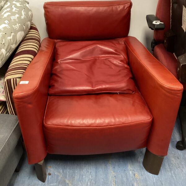 Red leather Natuzzi armchair, modern Italian design.