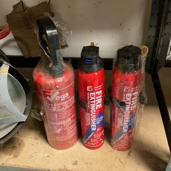 Lot of three vintage red fire extinguishers for collectors.