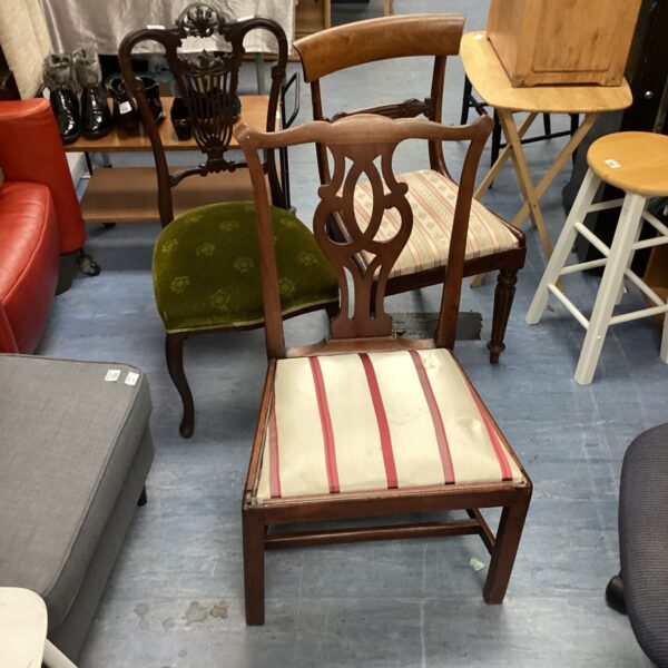 Vintage dining chair with patterned upholstered seat and carved wood.