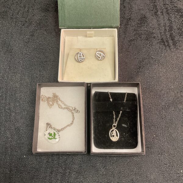 Vintage silver necklace and earrings set displayed in a box.