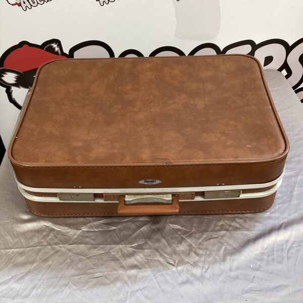 Vintage Foxcroft brown leather suitcase with a classic design.