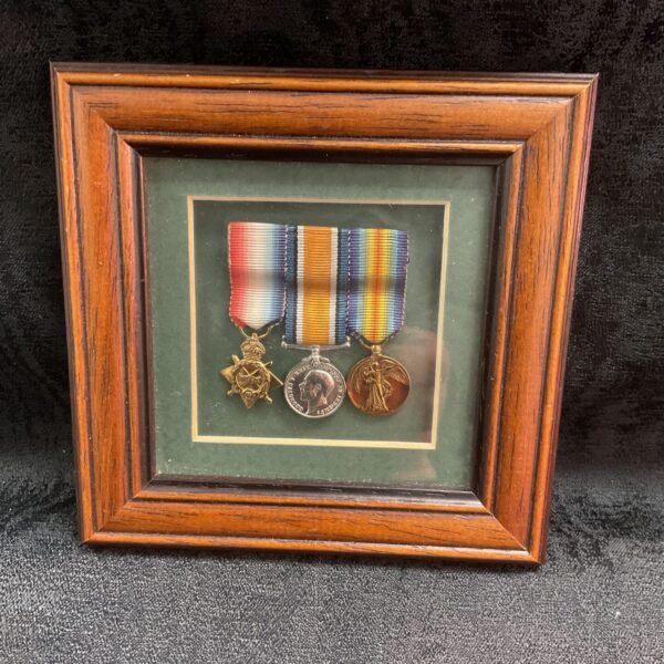 Framed WW1 miniature medals trio, a collectible set of Great War medals.