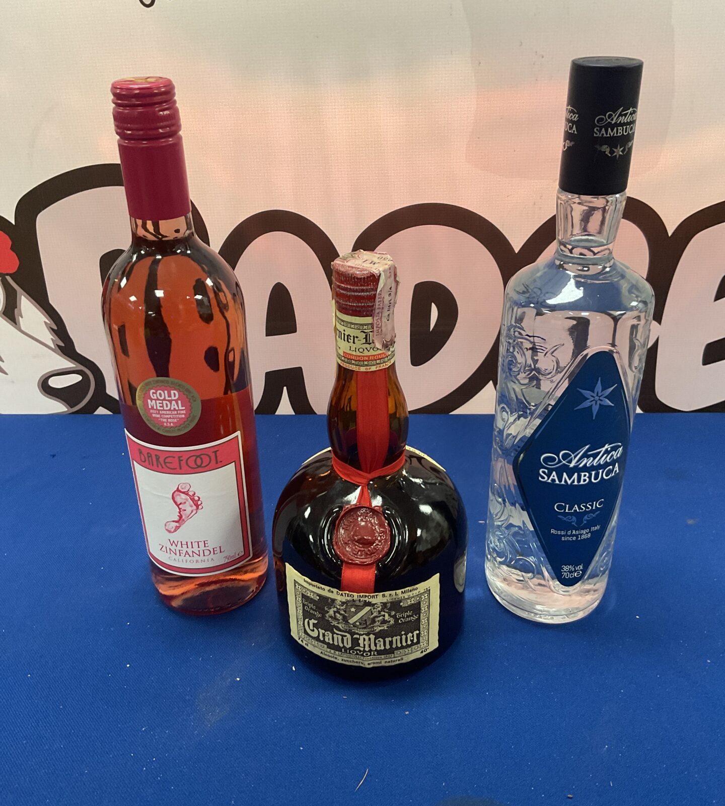 74cl bottle Grand Marnier, 70cl bottle Sambuka and bottle of white Zinfandel wine