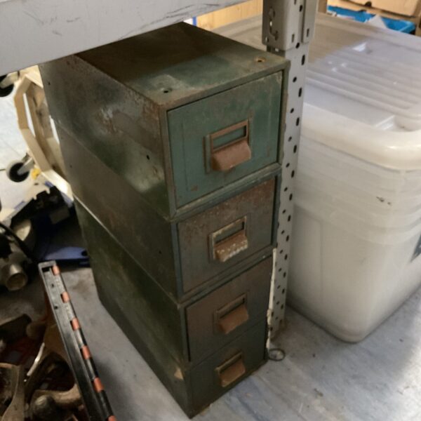 Set of four green vintage machinist drawers for workshop storage.