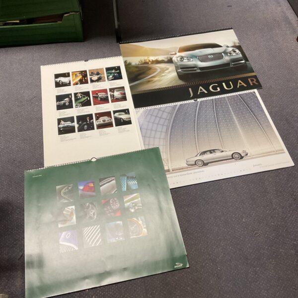 Vintage Jaguar calendars showcasing classic car designs.
