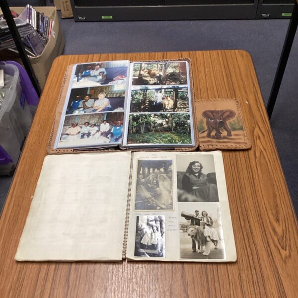 Vintage African photo album and leather folders with travel photos.
