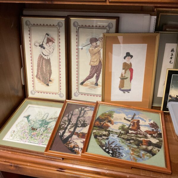 Vintage embroidered picture of a pilgrim woman in a detailed scene.