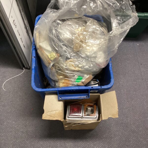 Blue box filled with military electrical spares and components.