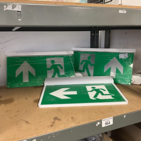 Illuminated fire exit sign with directional arrow for safety.