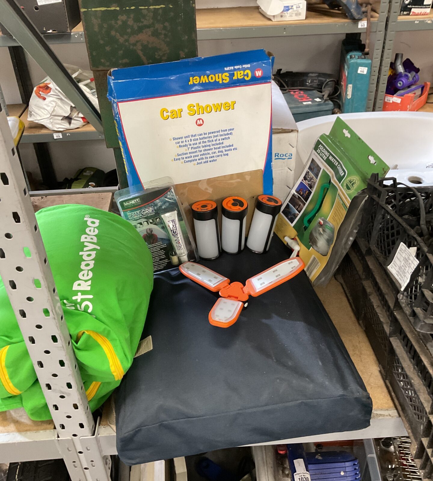 Lot of camping equipment including led lights, car powered shower & folding shelving unit