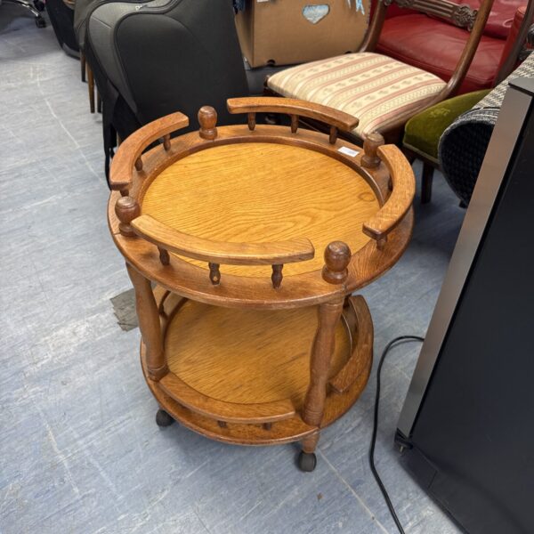 Vintage wooden drinks trolley with two tiers.