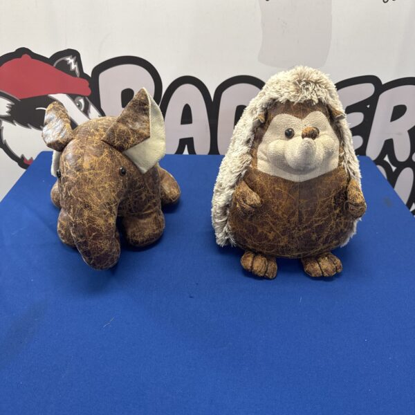 Vintage leather door stops featuring an elephant and hedgehog.