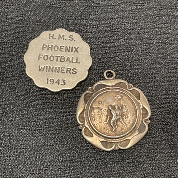 Vintage HMS Phoenix football medal from 1943, silver, detailed design.