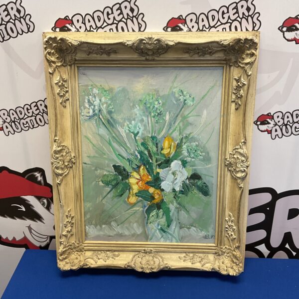 Vintage floral still life painting in ornate frame.