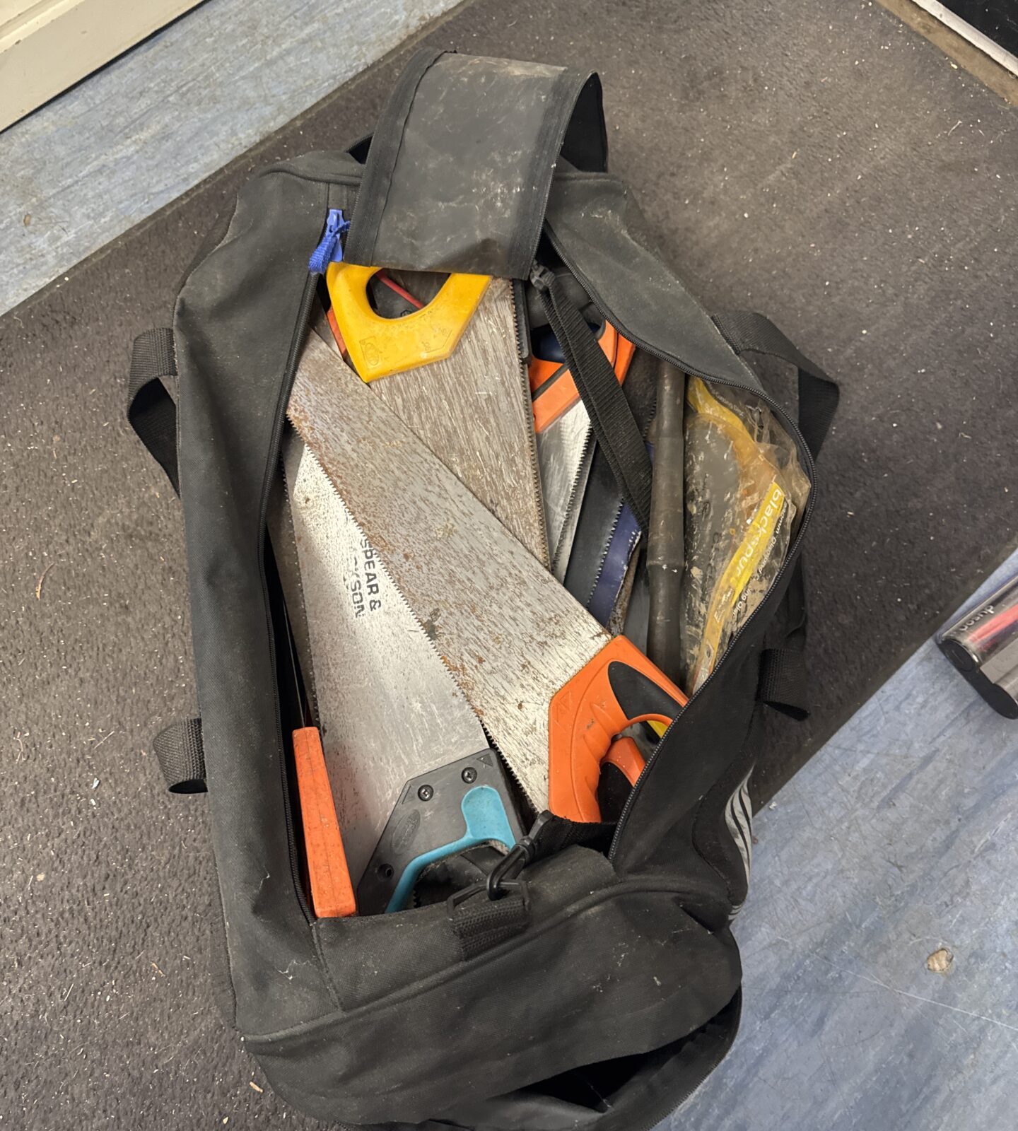 Large adidas hold-all full of tools - mostly saws