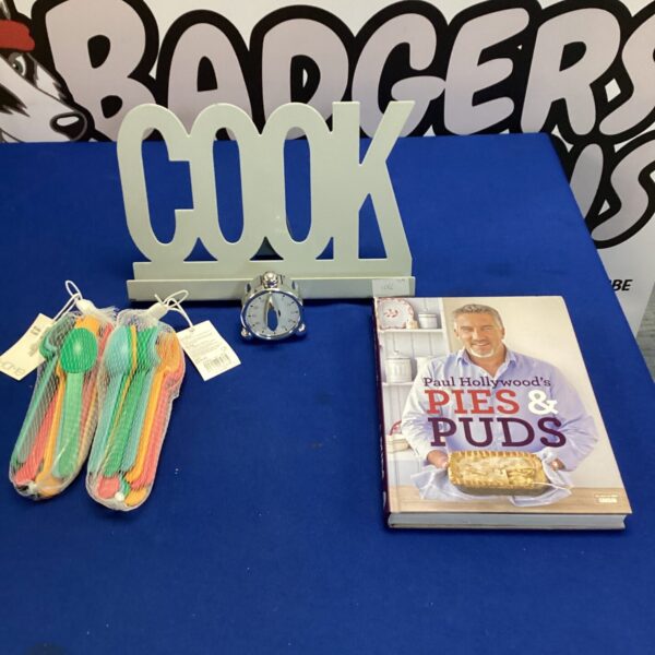 Paul Hollywood cookbook lot with egg timer and cutlery.
