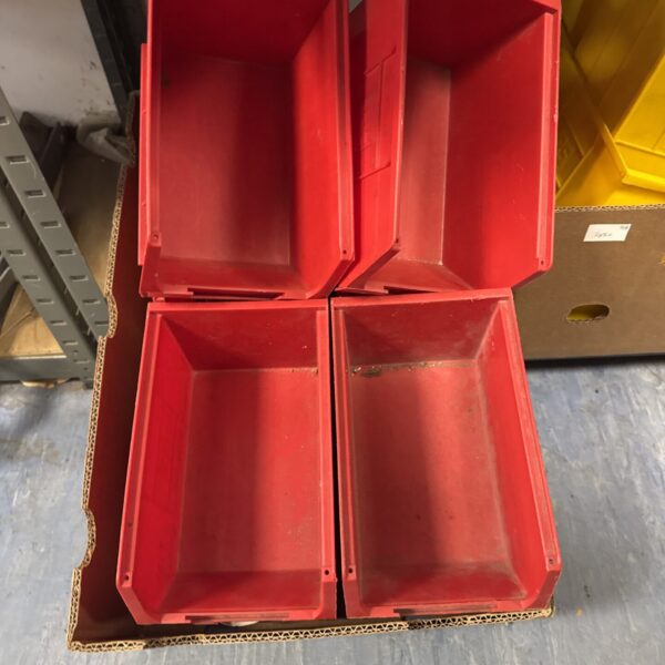 Front view of four large red storage trays.