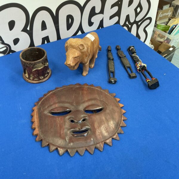 Collection of handcrafted African wood carvings and a mask.