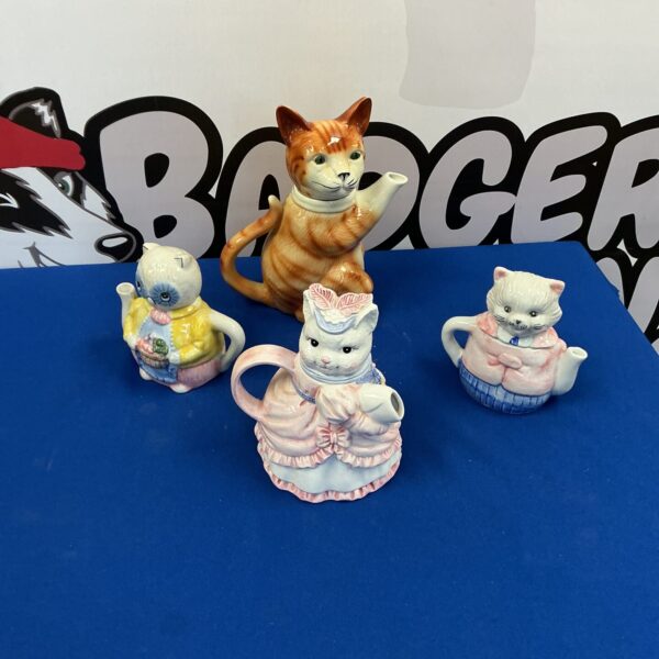 Four novelty tea pots inc Tony Wood Pottery