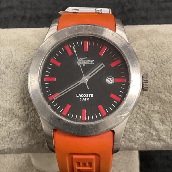 Vibrant orange Lacoste digital watch with rubber strap.