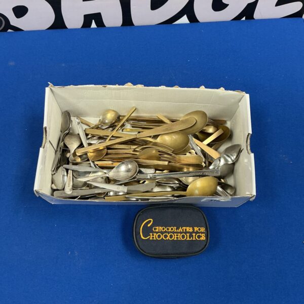 Vintage mixed cutlery lot with miniature boules on display.