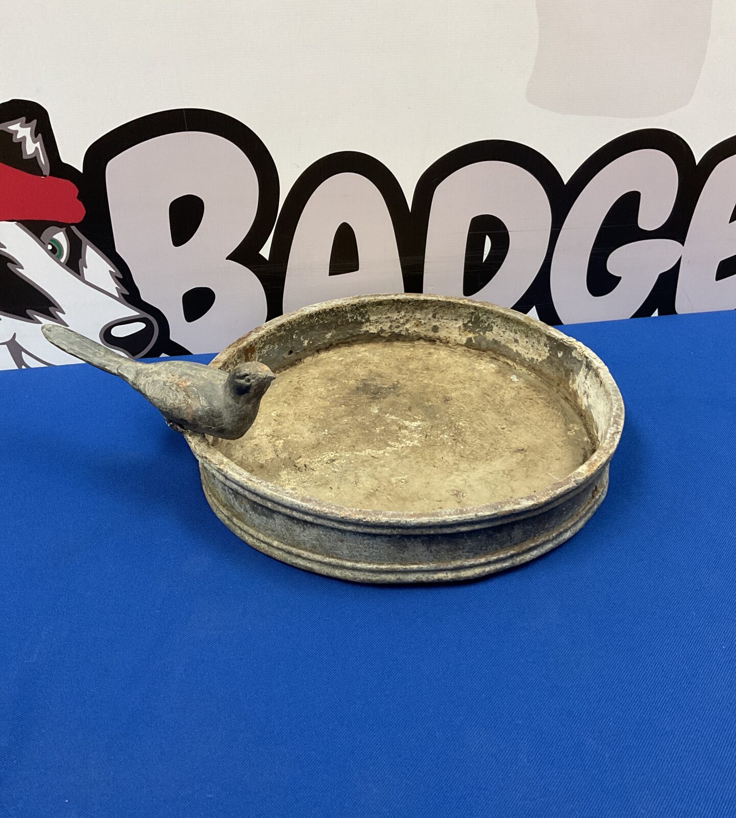 Antique lead bird bath with bird on edge