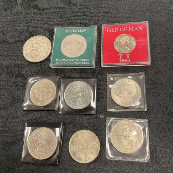 Isle of Man TT commemorative coins in protective holders.