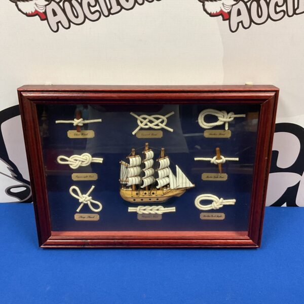 Vintage sail knot display case with nautical rope work.