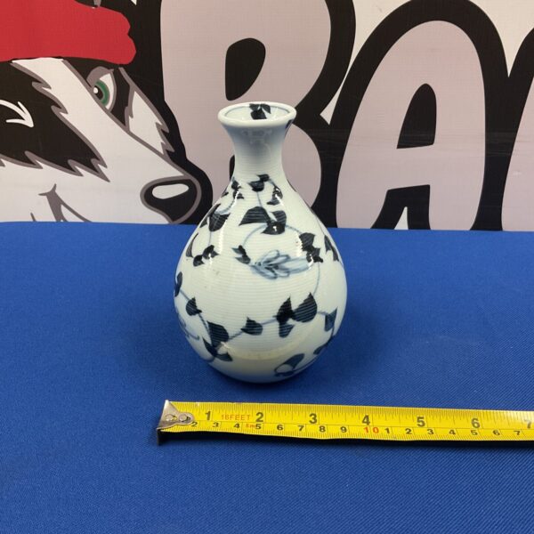 Antique Chinese blue and white porcelain vase with vine pattern.