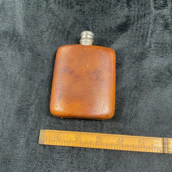 Vintage leather hip flask, a collectible pocket flask for spirits.
