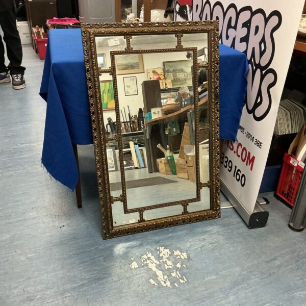 Ornate gilded antique mirror for wall decoration.