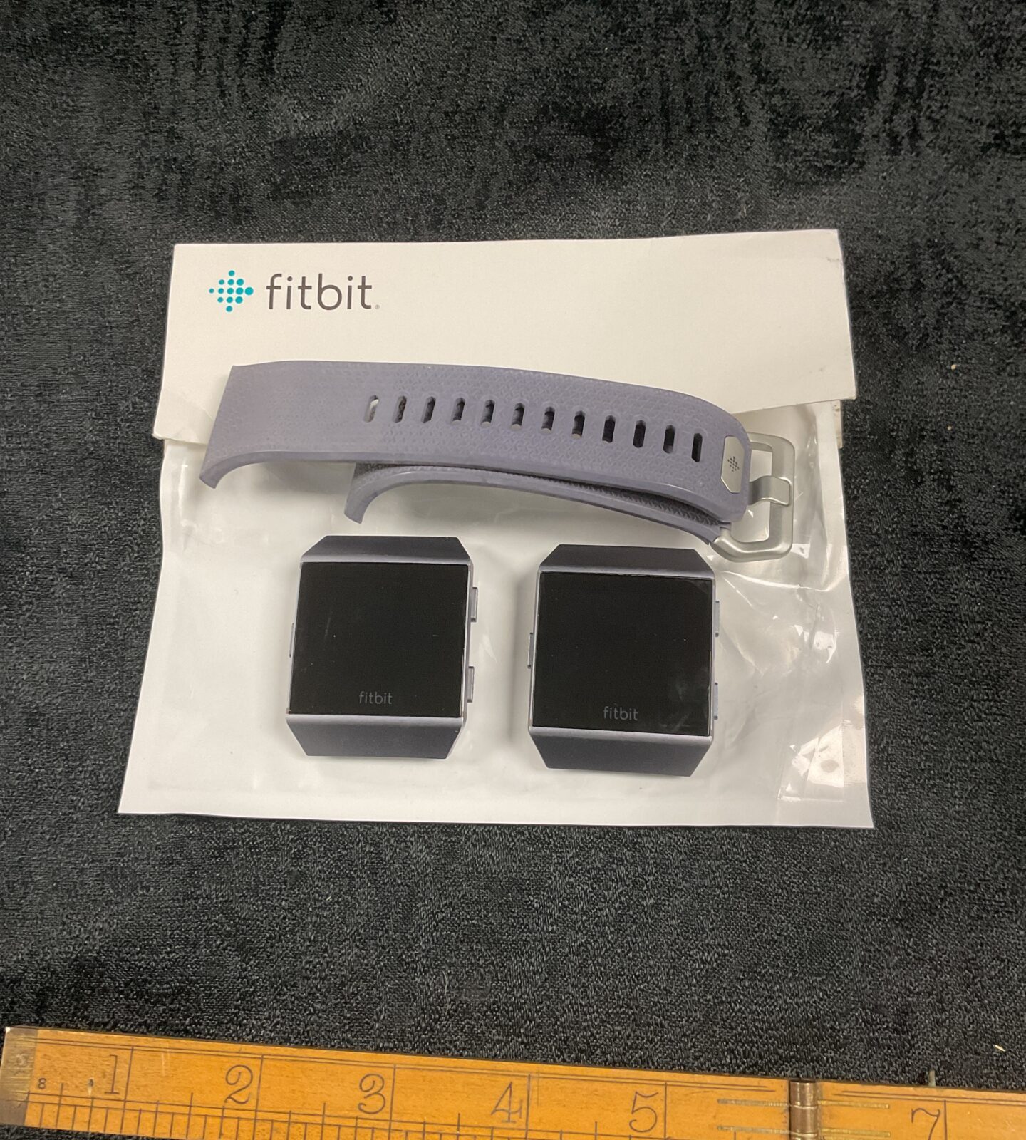 Two Fitbit watches one strap