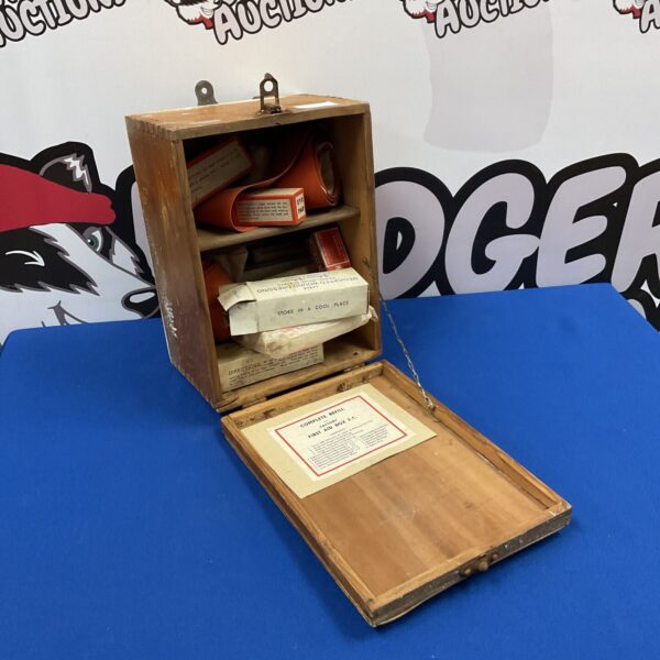 Open vintage wooden first aid box with contents visible.