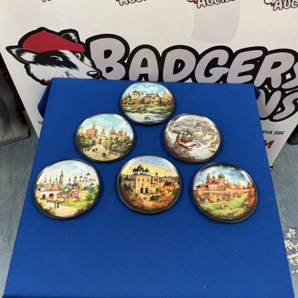 Collection of vintage Russian wall hanging plates with scenic artwork.