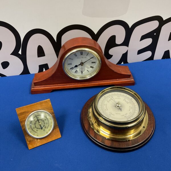 Vintage weather station set with barometer, clock, and thermometer.