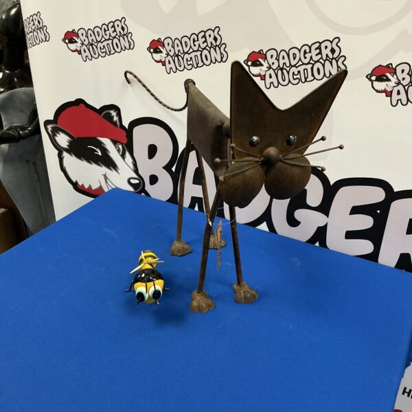 Vintage metal cat sculpture with bumblebee detail.