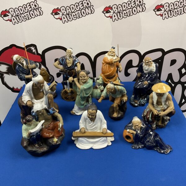 Group of eleven vintage Japanese mud men ornaments.
