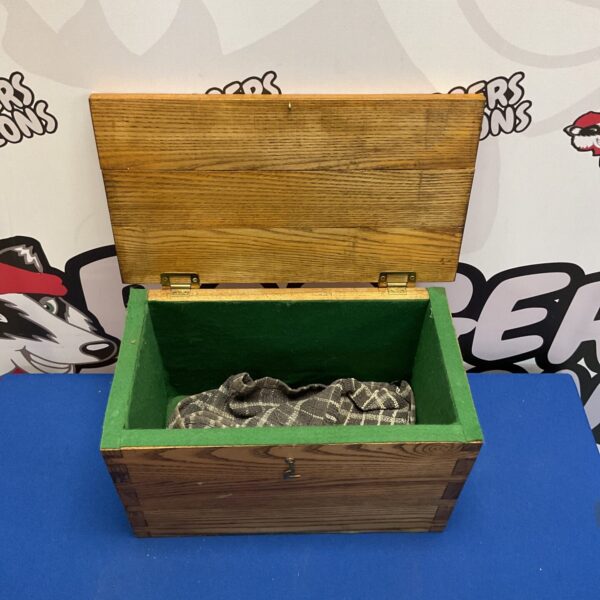 Vintage oak storage box with felt lining for collectibles.